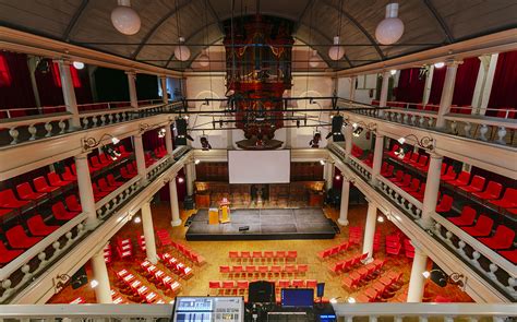 Interieur van De Rode Hoed met een podium en zitplaatsen