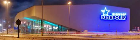 Artistieke foto van de buitenkant van Kinepolis Emmen, met nadruk op de moderne architectuur en verlichting.