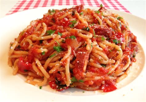 Gedetailleerde foto van een bord met spaghetti met salami en tomatensaus